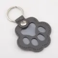 Grey leather paw-shaped keychain for pet hair collection and memorial identification. - 1 Piece / Black