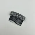 Detail of smokey grey crystal hair comb with non-slip black teeth for styling. - Gray