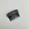 Close-up detail of a luxury black crystal hair comb with elegant rhinestone finish. - Blackish Purple