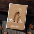 Detailed view of a vintage kraft paper greeting card with a laser-cut bear design. - Teddy Bear