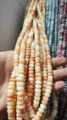 Handheld display of 4x8mm peach and white ice crack abacus beads for DIY jewelry craft - 50 Pieces/Pack / Warm Amber
