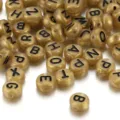 Premium golden acrylic round alphabet beads with black letters for DIY jewelry making - 100 Pieces/Pack / Gold With Printed Letters