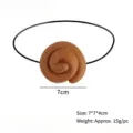 Detailed view of realistic brown spiral poop prank toy prop with 7cm size marker - One Size / Poop Eyepatch