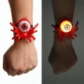 Comparison of a red Halloween spider eyeball bracelet in bright and glowing dark light - Red Spider Bracelet