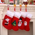 Set of large red Christmas stockings with felt appliques hanging on a white fireplace - White Border (Random Pattern)