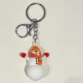 Detailaufnahme eines festlichen Schneemann Schlüsselanhängers mit Hut und Schal Details - Orangefarbener Schal Hut Dreifach Schneemann Stil / Weiß