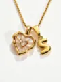 Detailed shot of gold stainless steel necklace with mother-of-pearl heart and letter S pendant. - S