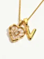 Detail view of gold stainless steel necklace with mother-of-pearl heart and letter V pendant. - Letter V