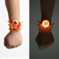 Close-up of a glowing Halloween spider wristband featuring a spooky eyeball design - Orange Spider Bracelet