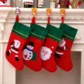 Four large festive Christmas stockings with Santa and Snowman patches hanging on mantel - Green Border (Random Pattern)