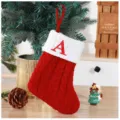 Close-up of red knitted Christmas stocking with white embroidered letter A - Red (A)