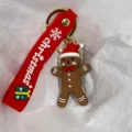 Detailaufnahme eines Lebkuchenmann-Schlüsselanhängers mit rotem festlichen Weihnachtsband - Lebkuchenmann mit Schleife