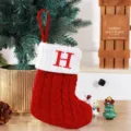 Red and white knitted Christmas stocking featuring a large embroidered red letter H initial. - Red (H)