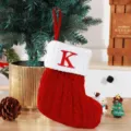 Festive knitted red Christmas stocking featuring white cuff and embroidered letter K detail - Red (K)