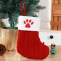 Festive red knitted Christmas stocking featuring a white cuff with a cute red paw print - Red (Paw Print)
