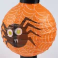 Dekorative orangefarbene Halloween-Papierlaterne mit Spinnennetz und Cartoon-Spinne - Spinnennetz-Stil / Orange