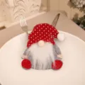 Detailed view of a Christmas gnome cutlery holder set on a white ceramic plate - Polka Dot Hat (Gnome) / Polka Dot Style