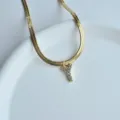 Detail view of the gold plated herringbone chain necklace featuring a sparkling crystal Y pendant. - Letter Y