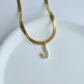 Gold herringbone chain necklace with sparkling cubic zirconia letter J pendant for women. - Letter J