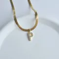 Gold herringbone chain necklace with crystal letter P pendant, minimalist chic jewelry style. - Letter P