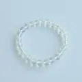 Close-up detail of clear crystal bead bracelet elastic string natural stone jewelry accessory. - 11# Opal