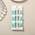 Set of six 3cm mini light blue macaron bow hair claw clips displayed on a pink retail card - 6 Pieces With Display Card / Pearlescent Mint Green