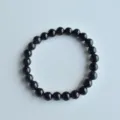 Detailed shot of a blue sandstone beaded elastic stretch bracelet, approx 8mm round beads. - 18# Blue Sandstone