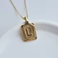 Close up detail view of a stylish gold stainless steel letter L square pendant necklace. - Letter L Square Pendant / Gold