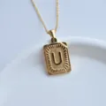 Gold stainless steel letter u pendant necklace detail shot, elegant fashion minimalist jewelry accessory. - Letter U Square Pendant / Gold
