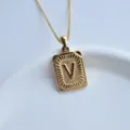 Close-up of gold stainless steel initial letter V square pendant necklace detail and texture. - Letter V Square Pendant / Gold