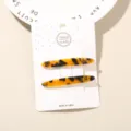 Set of two elegant tortoise shell acetate hair clips displayed on a white product card - 2-Piece Set (Card Packed) / Yellow Tortoiseshell (Arc Shape)