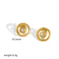 Detailed view of gold-tone spiral earrings featuring a sparkling central rhinestone accent. - Gold