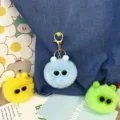 Detail shot of cute furry pom pom keychains with sunglasses in blue, yellow, and green. - Sky Blue