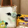 Cute plush bat monster keychain featuring a fuzzy pompom body and large googly eyes - Single OPP Bag Packaging / Green