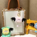 Detail shot of cute colorful plush bat monster keychains hanging on bag and props - Single OPP Bag Packaging / Pink