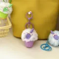 Close-up of cute purple furry ice cream cone keychain charm hanging on a yellow bag - Purple