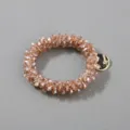 Detailed view of handmade beaded hair scrunchie with faceted champagne crystal beads - Champagne