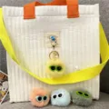 Close-up of colorful plush monster pom-pom keychains with funny sunglasses and pearls. - Single OPP Bag Packaging / Goose Yellow