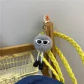 Cute 3D grey pom-pom character keychain with sunglasses and tiny black shoes detail - Gray