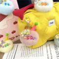 Close-up detail of a colorful plush ice cream pom-pom keychain used as a bag charm. - Single OPP Bag Packaging / Dusky Pink