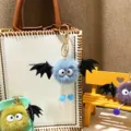 Detailed view of cute plush bat monster keychains with soft fur and black wings - Single OPP Bag Packaging / Sky Blue