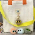 Cute furry monster ball keychains with sunglasses and pearl charm attached to a white bag - Single OPP Bag Packaging / Khaki
