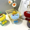 Detailed group view of colorful furry monster keychains with mini knitted hats for bags - Sky Blue