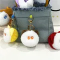 Close-up of plush cat head keychains hanging on a denim bag as cute decorative accessories. - Cat Head Style (PJMQ81022) / Single Piece / Khaki