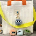 Cute plush monster pom-pom keychains with sunglasses and pearls shown in a close-up detail - Single OPP Bag Packaging / Haze Blue
