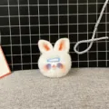 Close-up detail of a soft white plush bunny keychain with blue hairclip accessory - Single OPP Bag Packaging / Blue