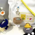 Set of cute fluffy plush monster charms with knitted hats shown as bag accessories - Khaki