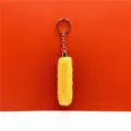Detailed view of soft yellow fluffy faux fur keychain with polished gold-tone metal ring - Yellow
