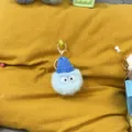Close-up detail of a fuzzy blue monster plush keychain with a mini knitted blue hat - 1 Piece / Sky Blue