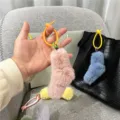 Colorful plush sock charms with silicone rings displayed as bag accessories in detail. - Single OPP Bag Packaging / Dusky Pink